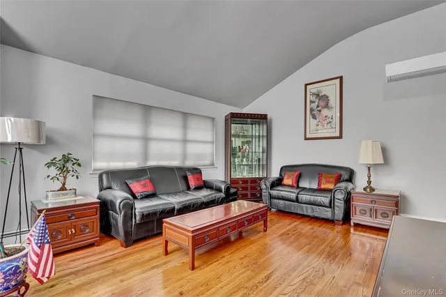 a living room with furniture a rug and a window