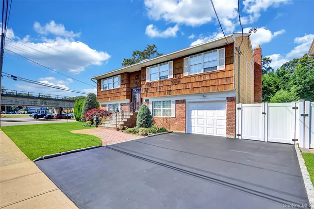 a front view of a house with a yard and outdoor seating