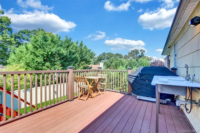 a balcony with wooden floor table and chairs