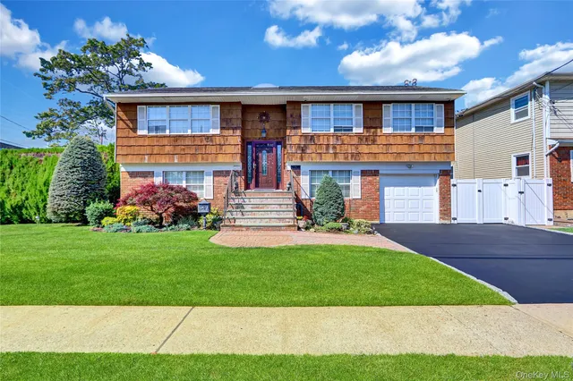 a front view of a house with a yard and garage