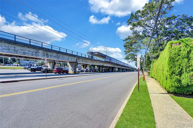 a swimming pool with yard in front of it