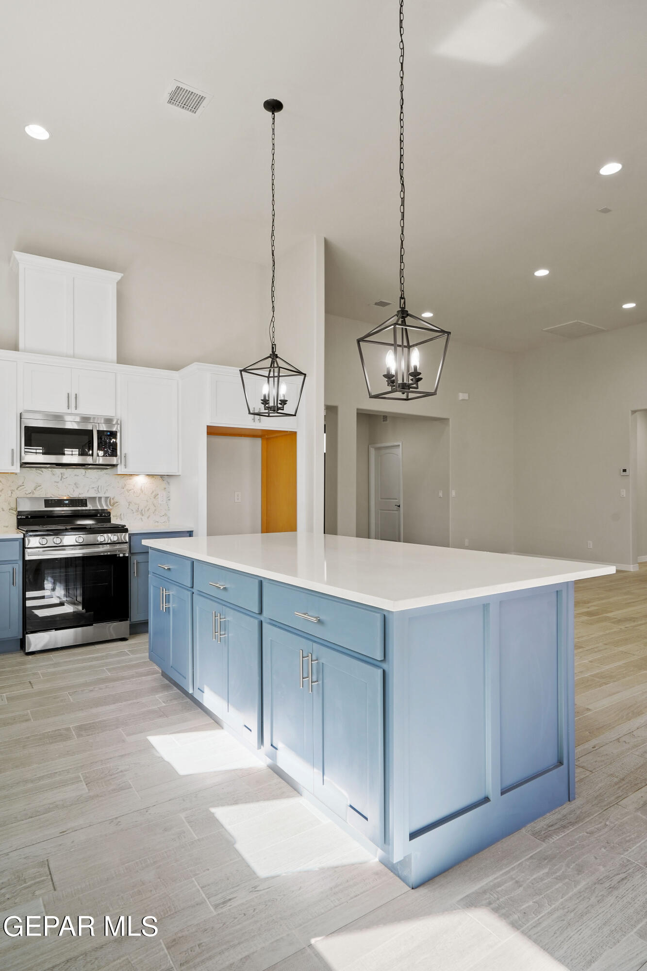 1734 Bit Way El Paso, TX 79911 - Photo 11 of 52 a kitchen with kitchen island sink and stove