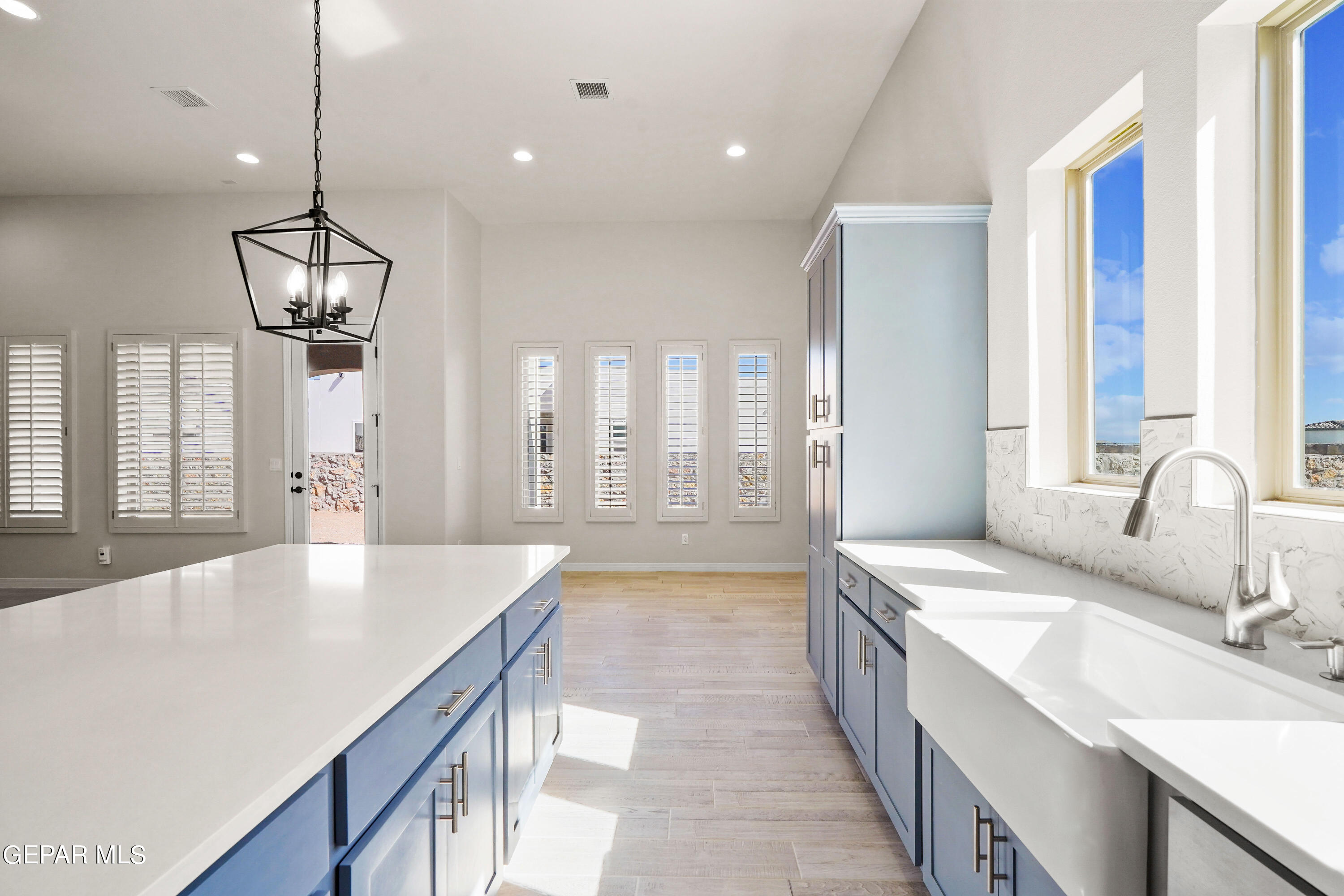 1734 Bit Way El Paso, TX 79911 - Photo 15 of 52 a large kitchen with kitchen island a large counter space a sink stainless steel appliances and cabinets
