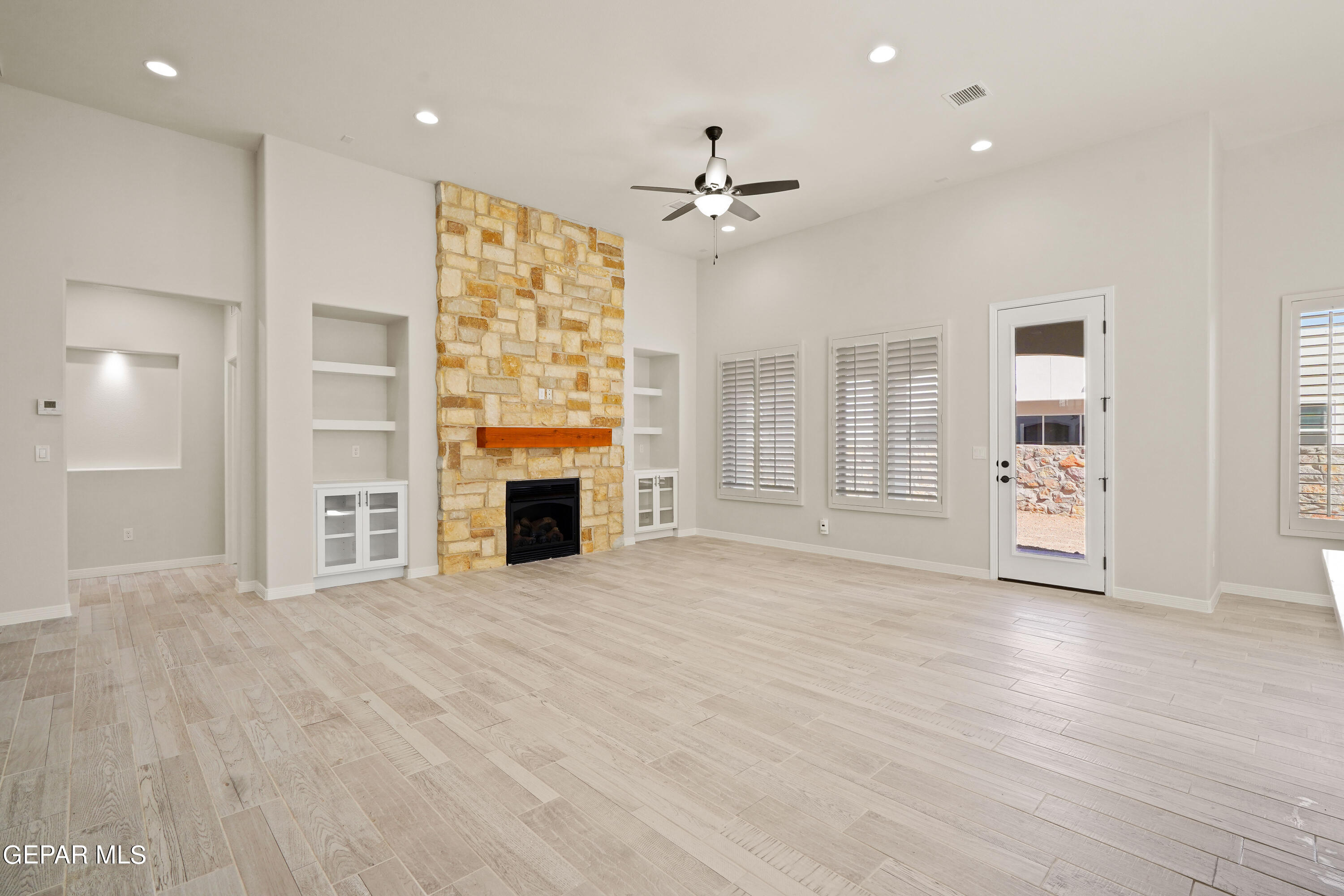 1734 Bit Way El Paso, TX 79911 - Photo 16 of 52 a view of an empty room with a fireplace and a window