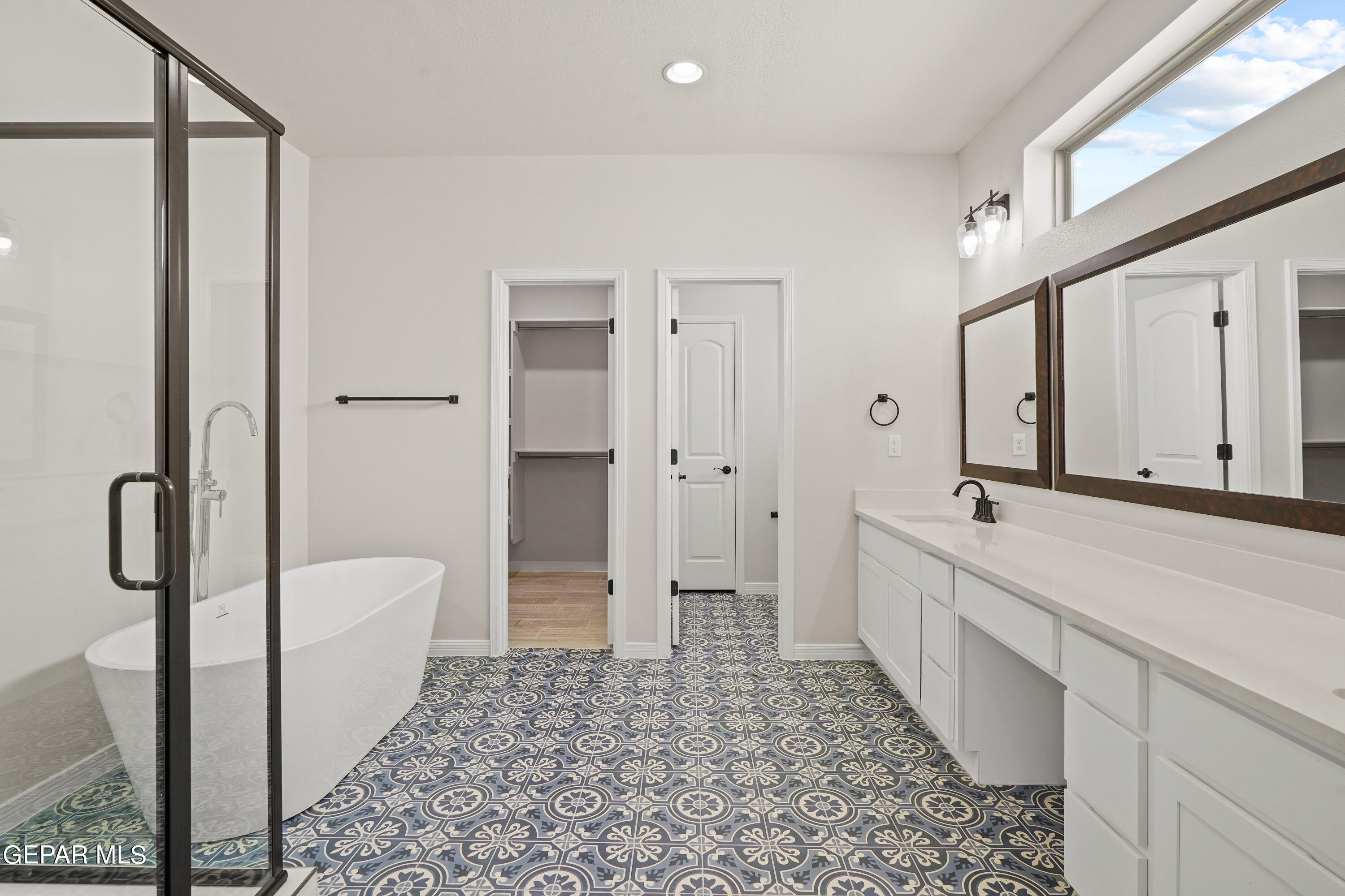 1734 Bit Way El Paso, TX 79911 - Photo 23 of 52 a bathroom with a tub a sink and a large window