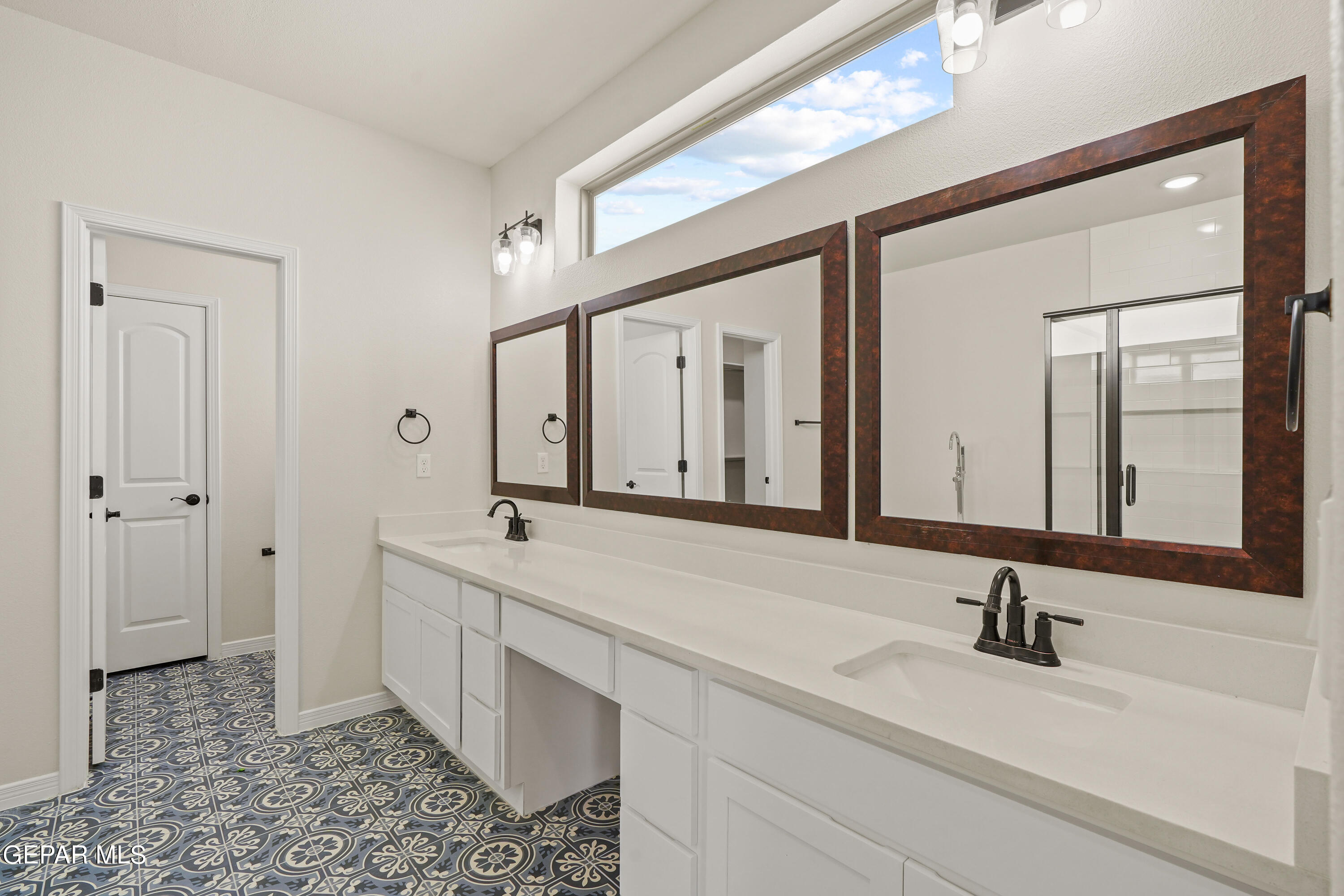 1734 Bit Way El Paso, TX 79911 - Photo 25 of 52 a bathroom with a double vanity sink and a mirror