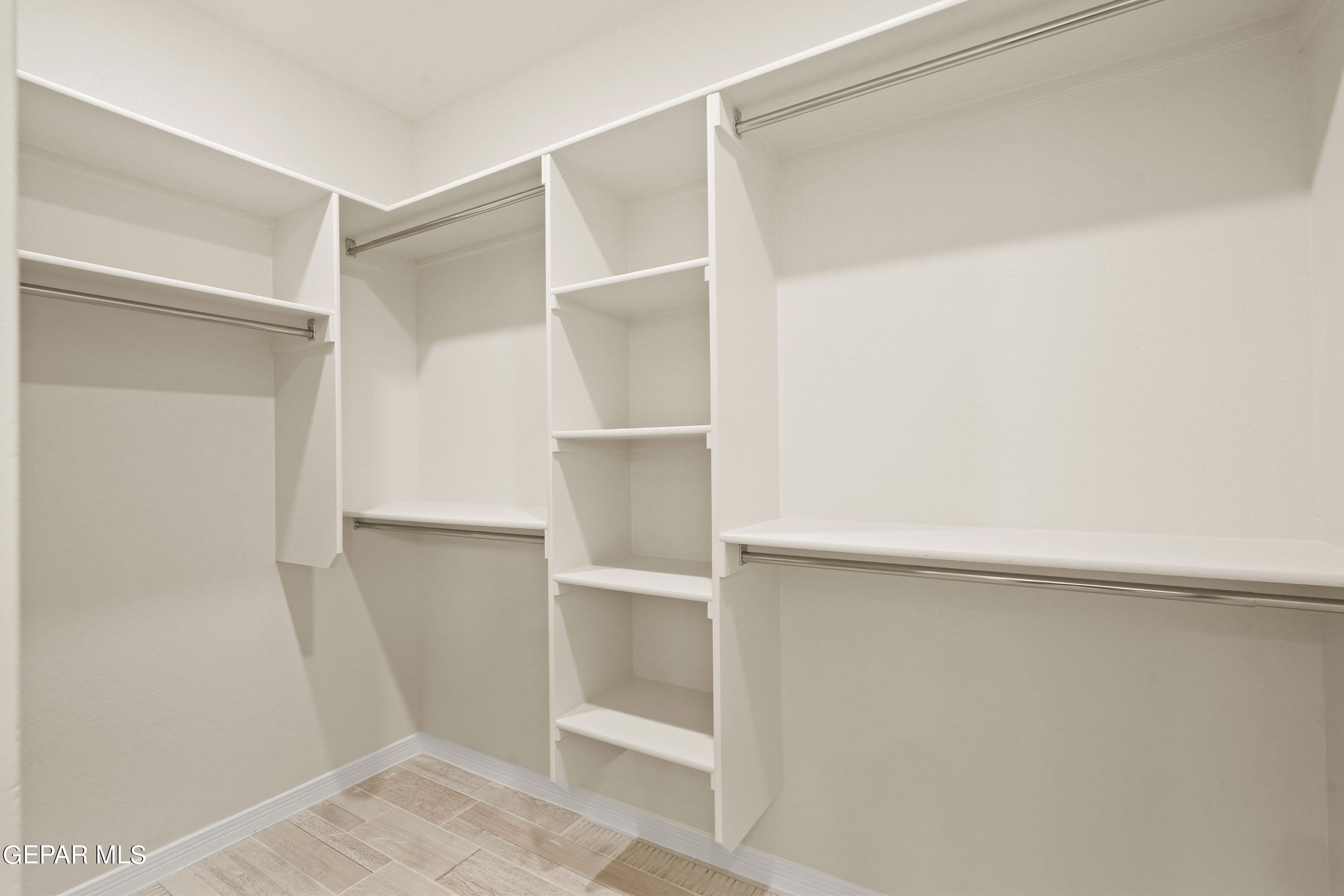 1734 Bit Way El Paso, TX 79911 - Photo 36 of 52 a view of walk in closet with empty racks