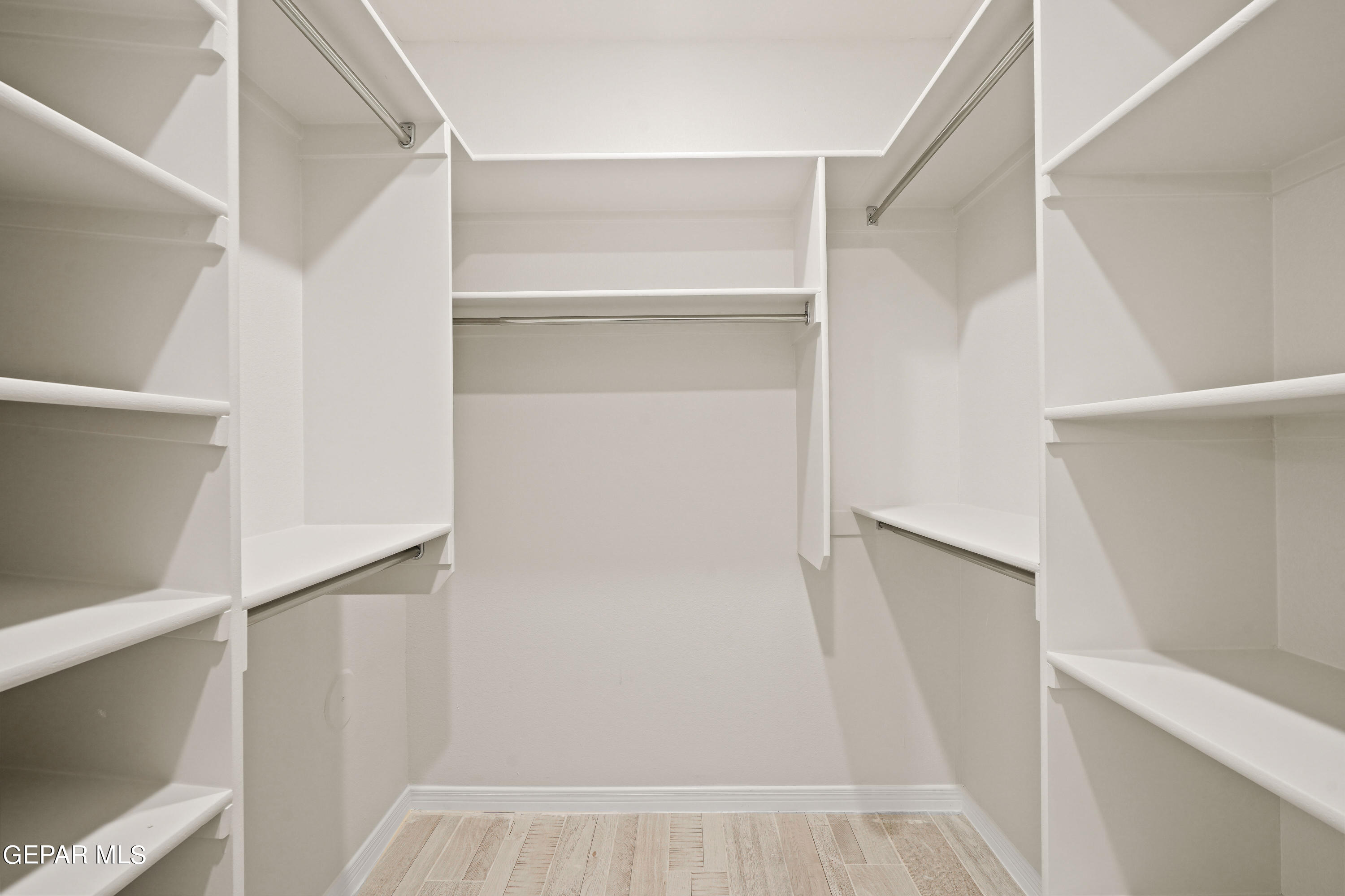 1734 Bit Way El Paso, TX 79911 - Photo 37 of 52 a view of walk in closet with empty racks