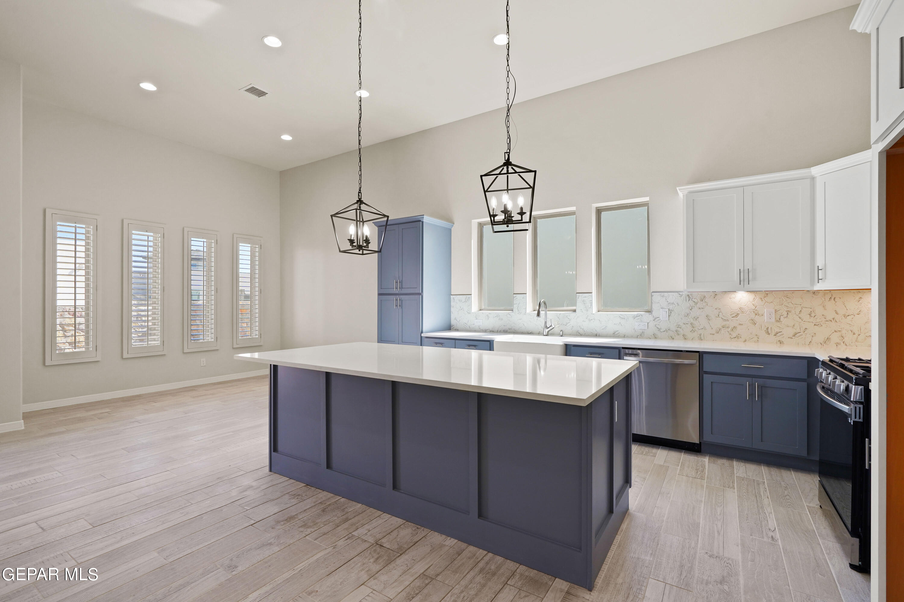 1734 Bit Way El Paso, TX 79911 - Photo 3 of 52 a large kitchen with stainless steel appliances granite countertop a sink a stove and a wooden floors