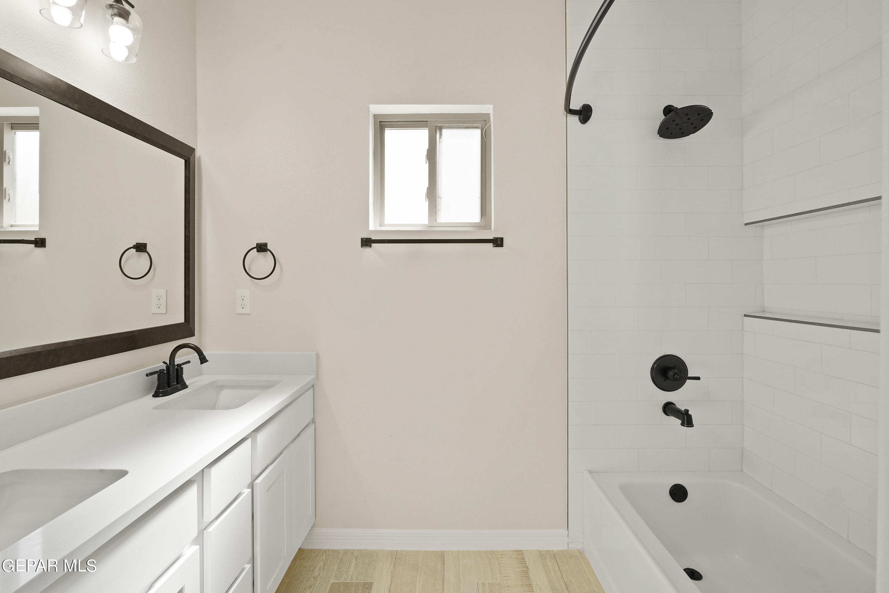 1734 Bit Way El Paso, TX 79911 - Photo 40 of 52 a bathroom with a tub shower vanity and a sink