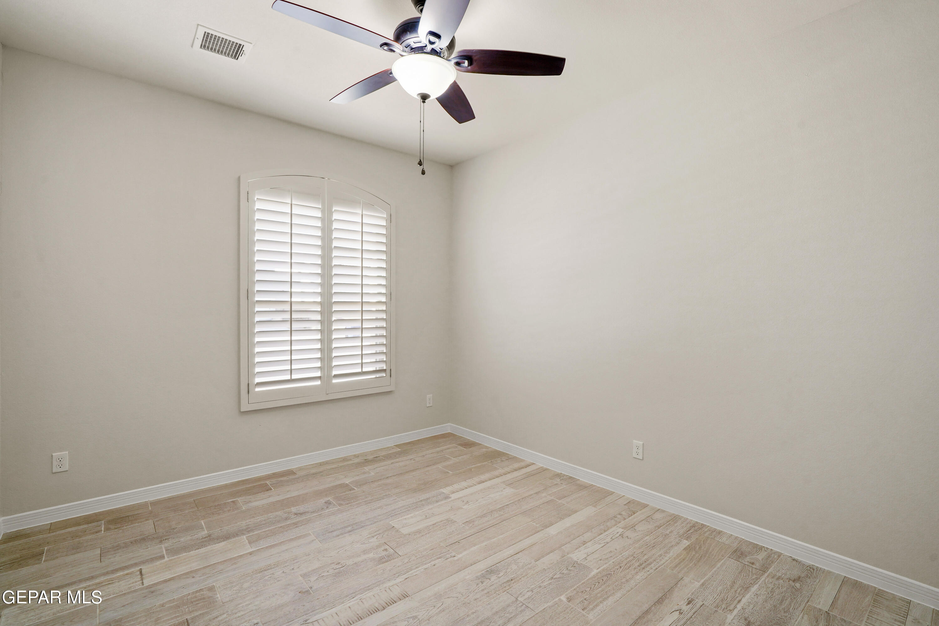 1734 Bit Way El Paso, TX 79911 - Photo 44 of 52 an empty room with a window and a fan