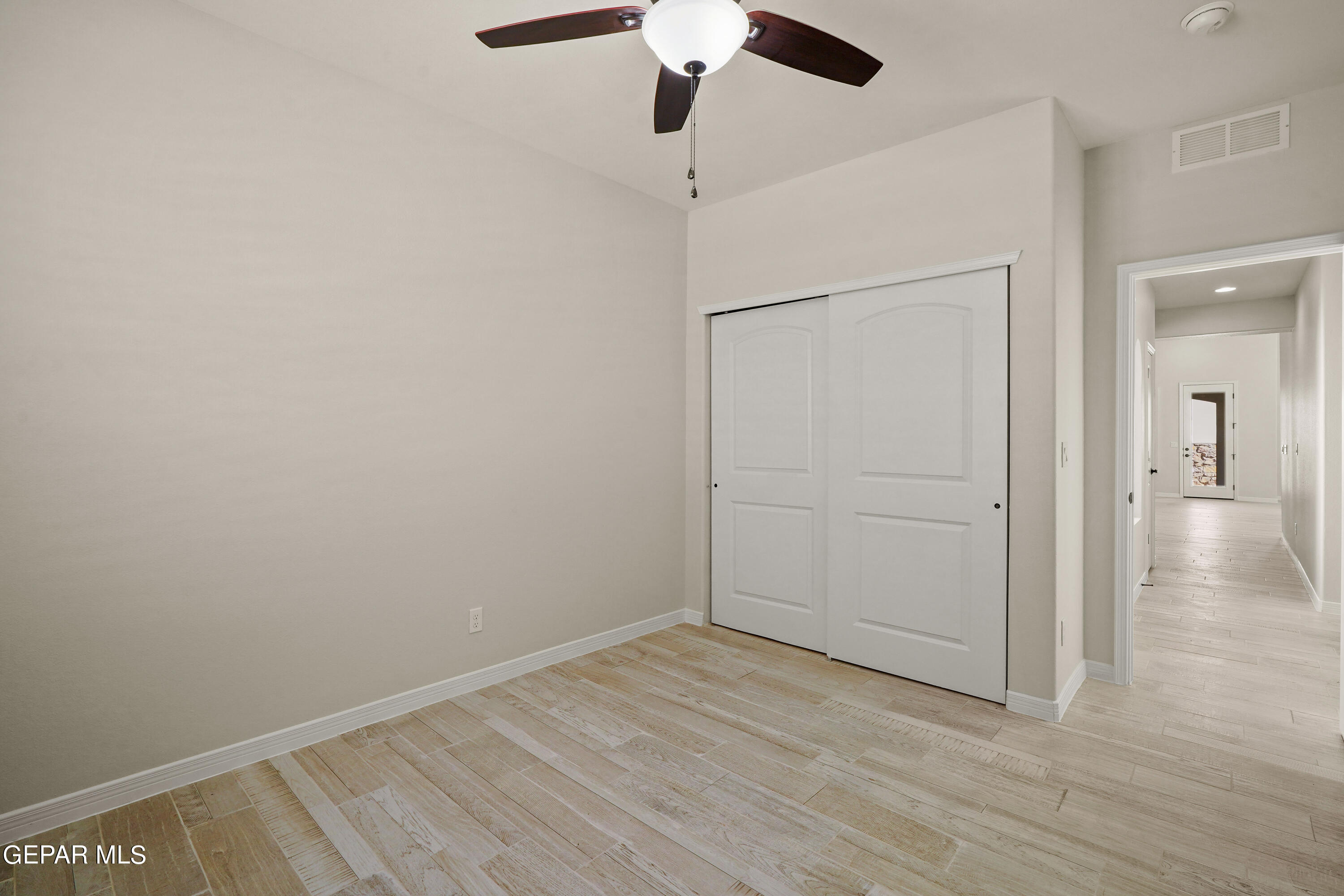 1734 Bit Way El Paso, TX 79911 - Photo 45 of 52 a view of an empty room with wooden floor