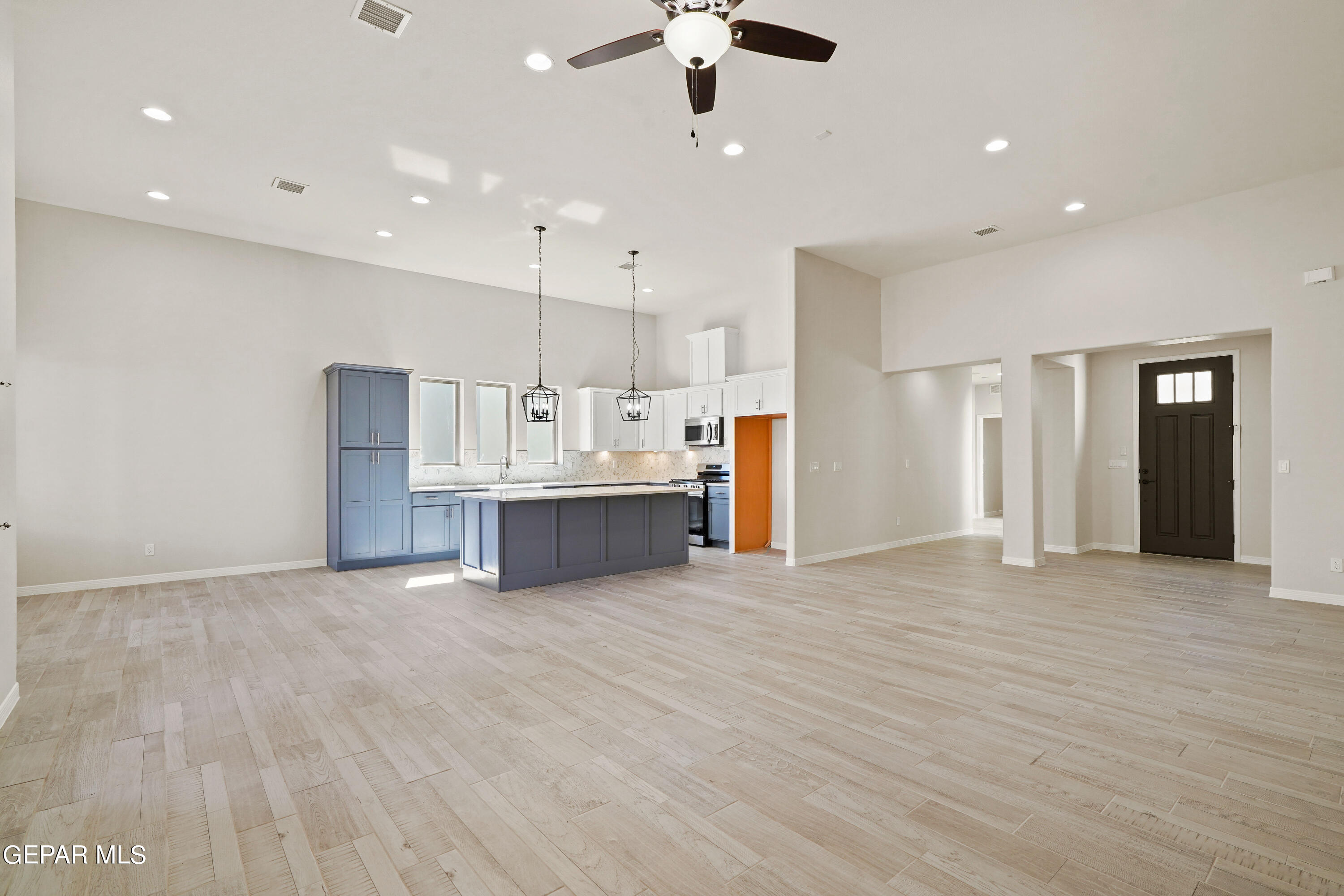 1734 Bit Way El Paso, TX 79911 - Photo 4 of 52 a view of kitchen with kitchen island white cabinets and refrigerator