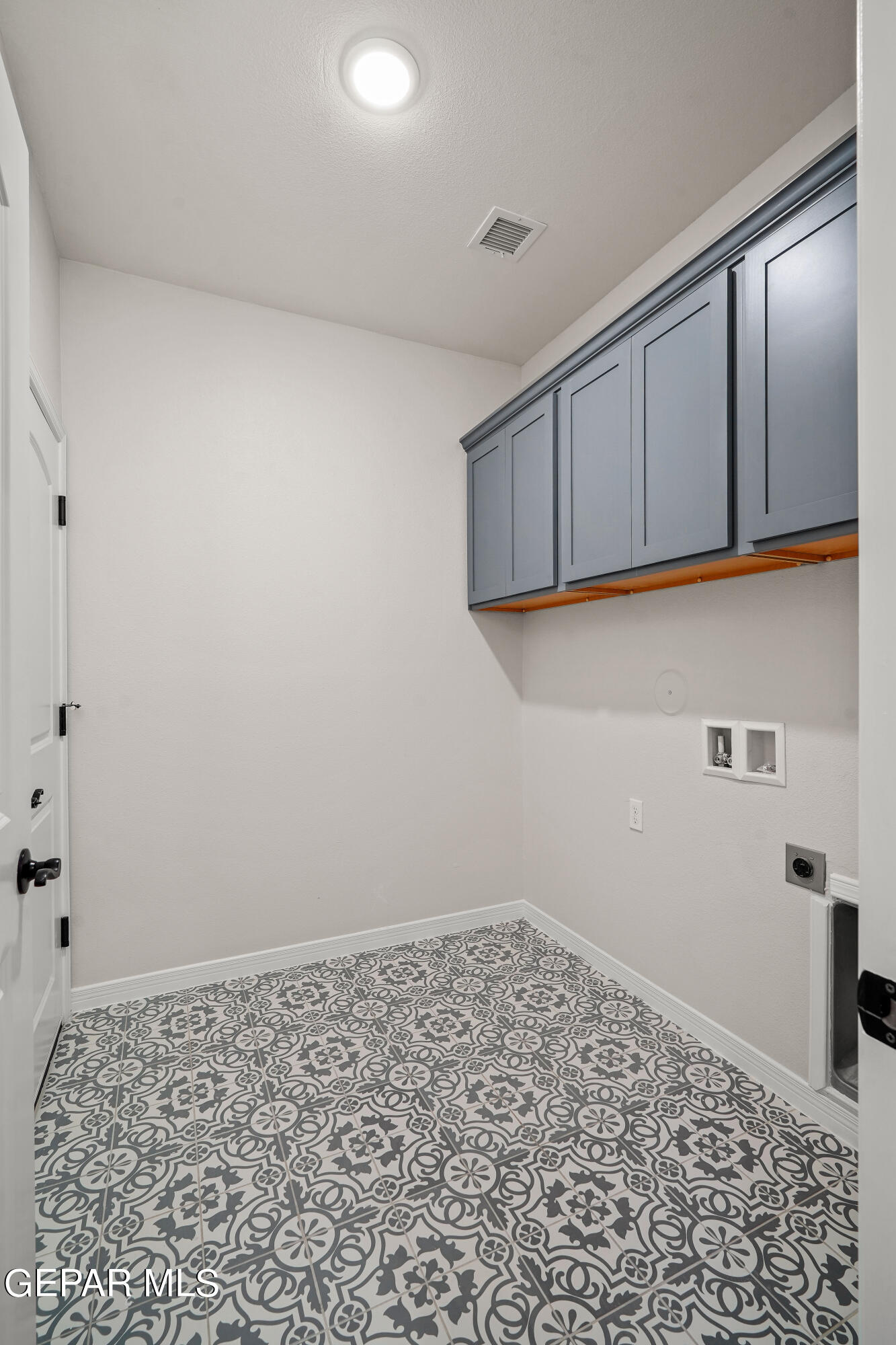 1734 Bit Way El Paso, TX 79911 - Photo 50 of 52 a room with a wooden floor and cabinets