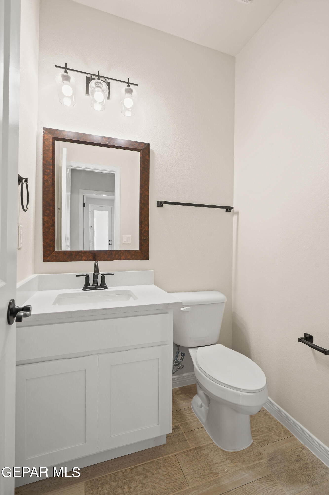 1734 Bit Way El Paso, TX 79911 - Photo 51 of 52 a bathroom with a toilet a sink and mirror