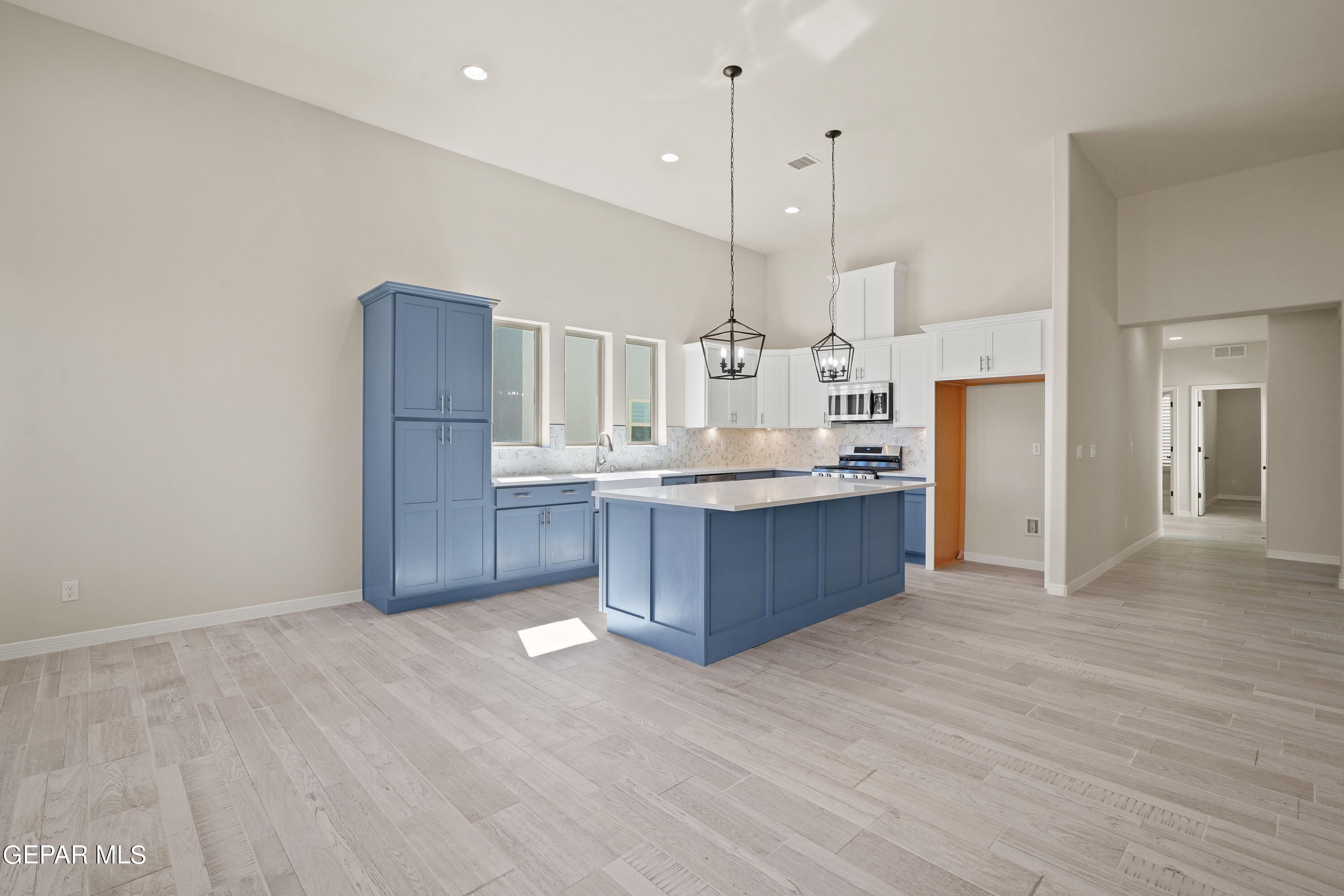 1734 Bit Way El Paso, TX 79911 - Photo 6 of 52 a large kitchen with a large counter top a sink stainless steel appliances and cabinets