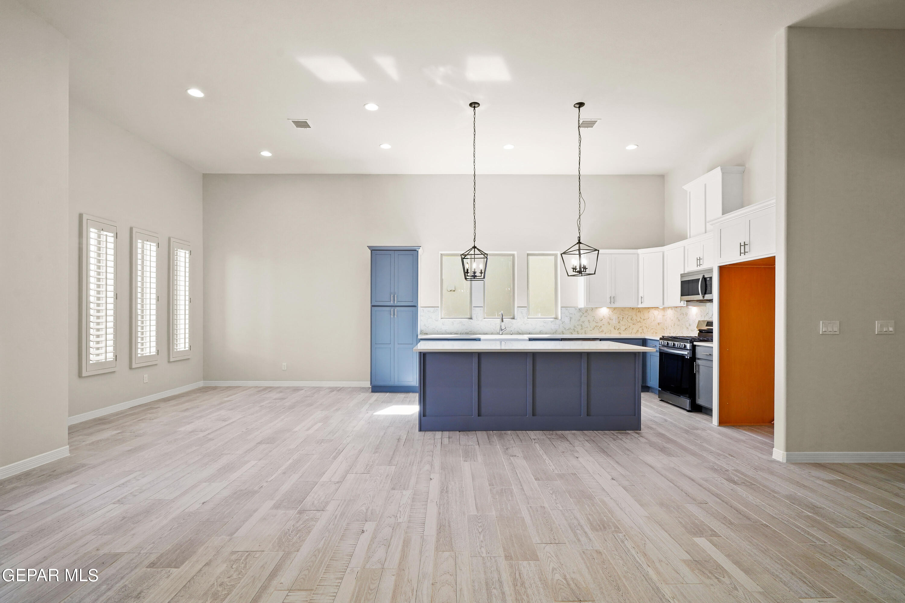 1734 Bit Way El Paso, TX 79911 - Photo 7 of 52 a large kitchen with stainless steel appliances kitchen island a large counter top and a wooden floors