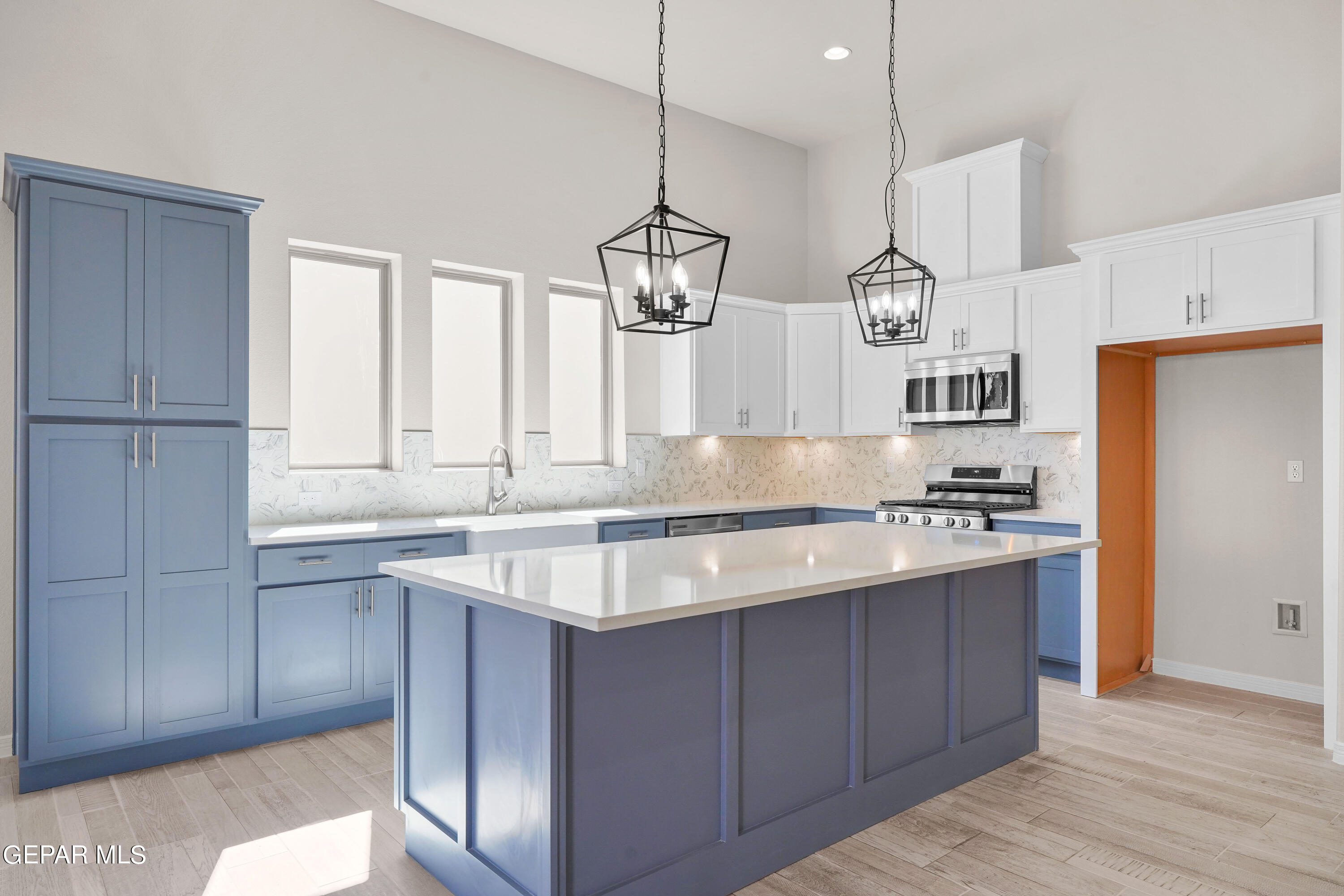 1734 Bit Way El Paso, TX 79911 - Photo 8 of 52 a kitchen with stainless steel appliances granite countertop a sink a stove a refrigerator and island with wooden floor