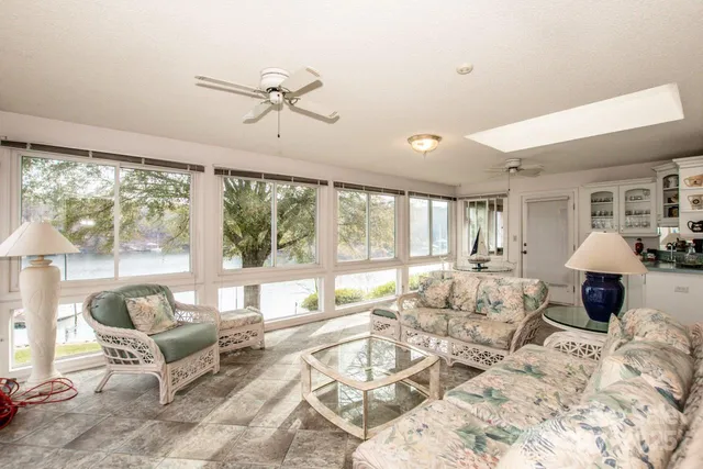 a living room with furniture and large windows