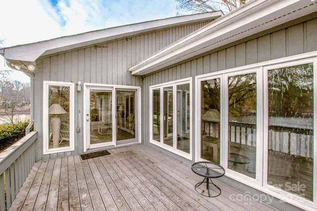a front view of a house with wooden floor and outdoor seating