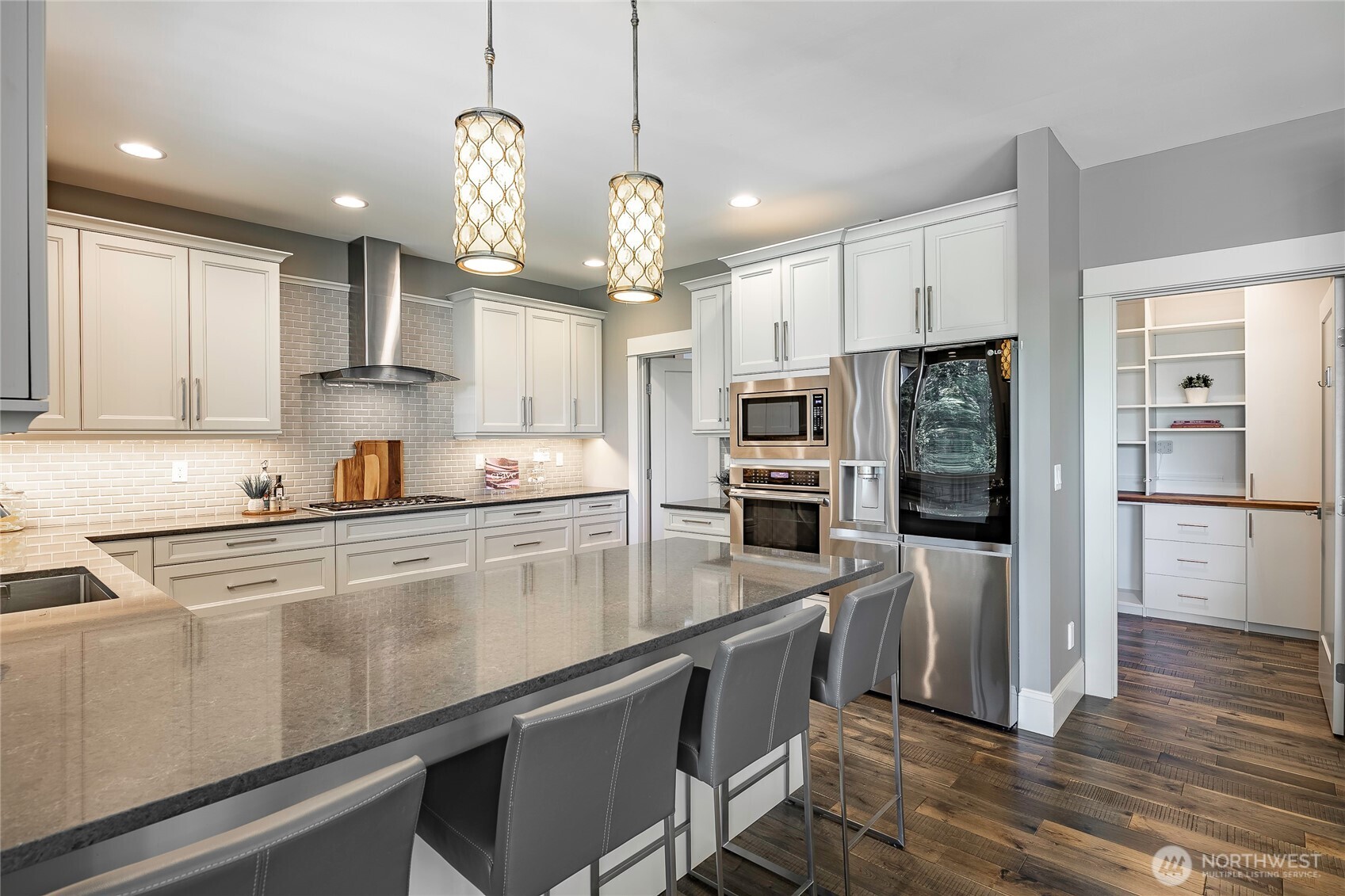 9125 Shearwater Road Blaine, WA 98230 - Photo 13 of 40 a kitchen with stainless steel appliances granite countertop a refrigerator a sink dishwasher a stove and white cabinets with wooden floor