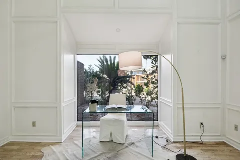 a dining room with furniture and wooden floor
