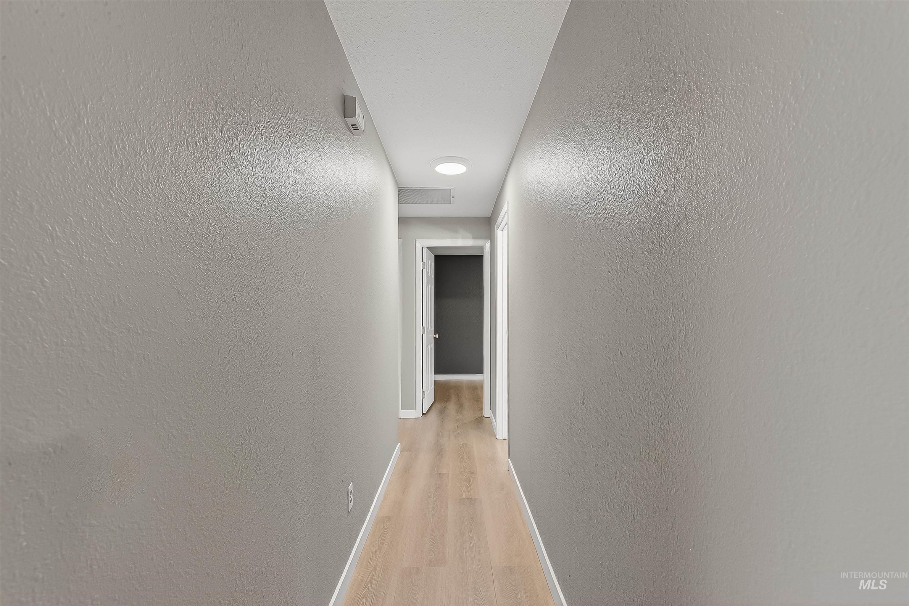 406 2nd Street Asotin, WA 99402 - Photo 12 of 37 Corridor featuring a textured wall and light wood-style flooring