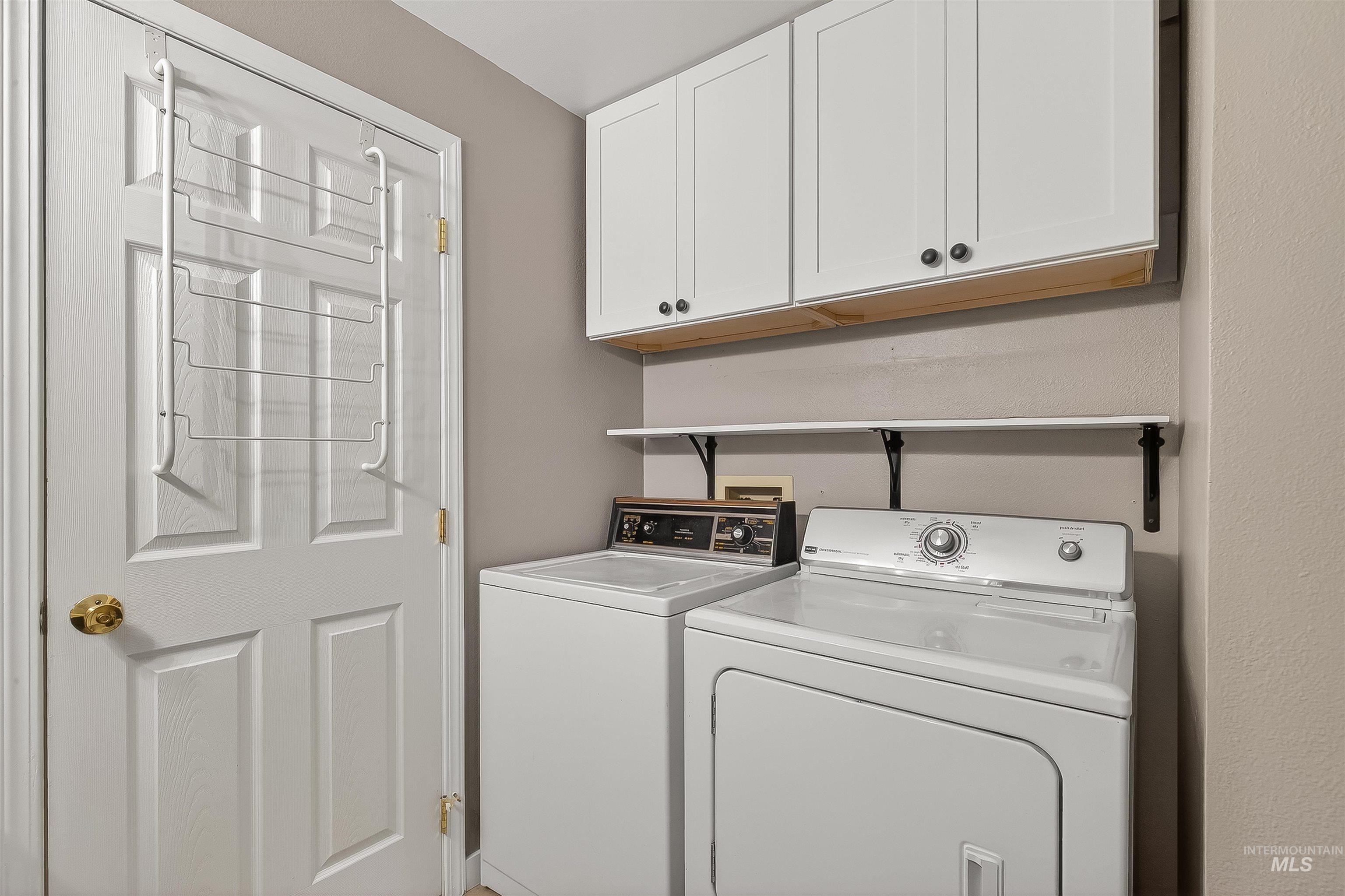 406 2nd Street Asotin, WA 99402 - Photo 16 of 37 Laundry room with cabinet space and separate washer and dryer