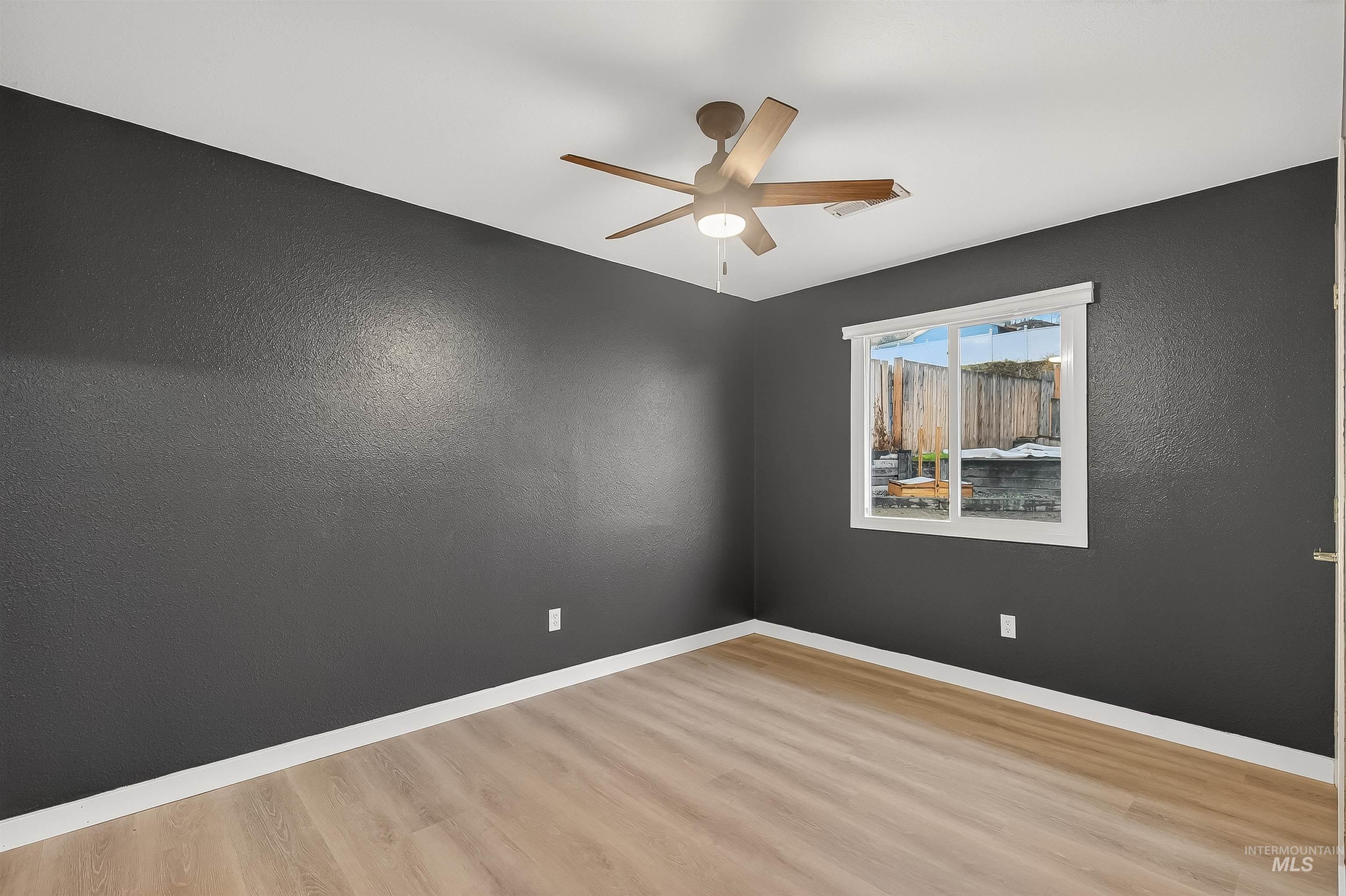 406 2nd Street Asotin, WA 99402 - Photo 19 of 37 Spare room featuring a textured wall, light wood-type flooring, and a ceiling fan