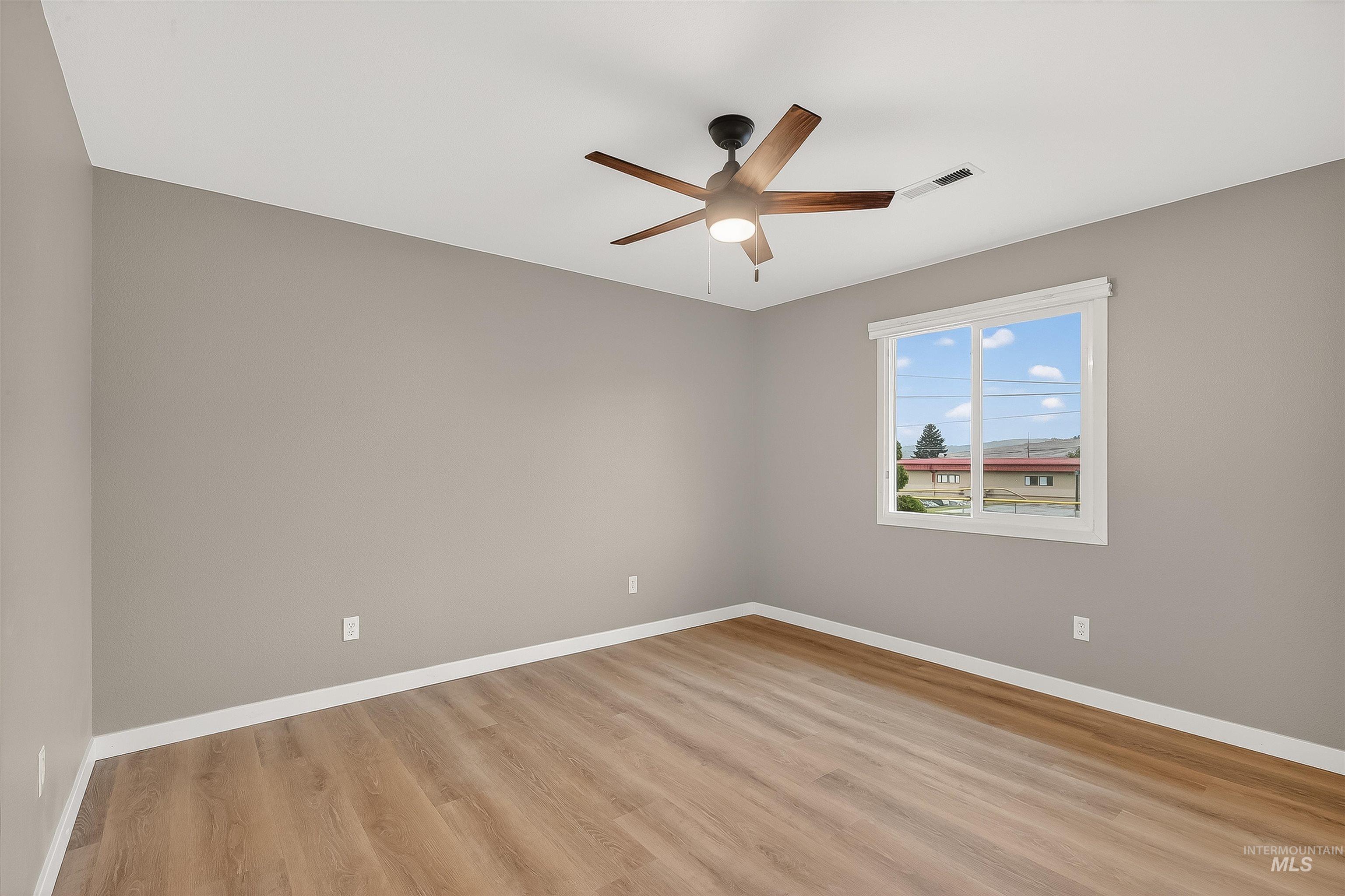 406 2nd Street Asotin, WA 99402 - Photo 21 of 37 Unfurnished room with light wood-type flooring and ceiling fan
