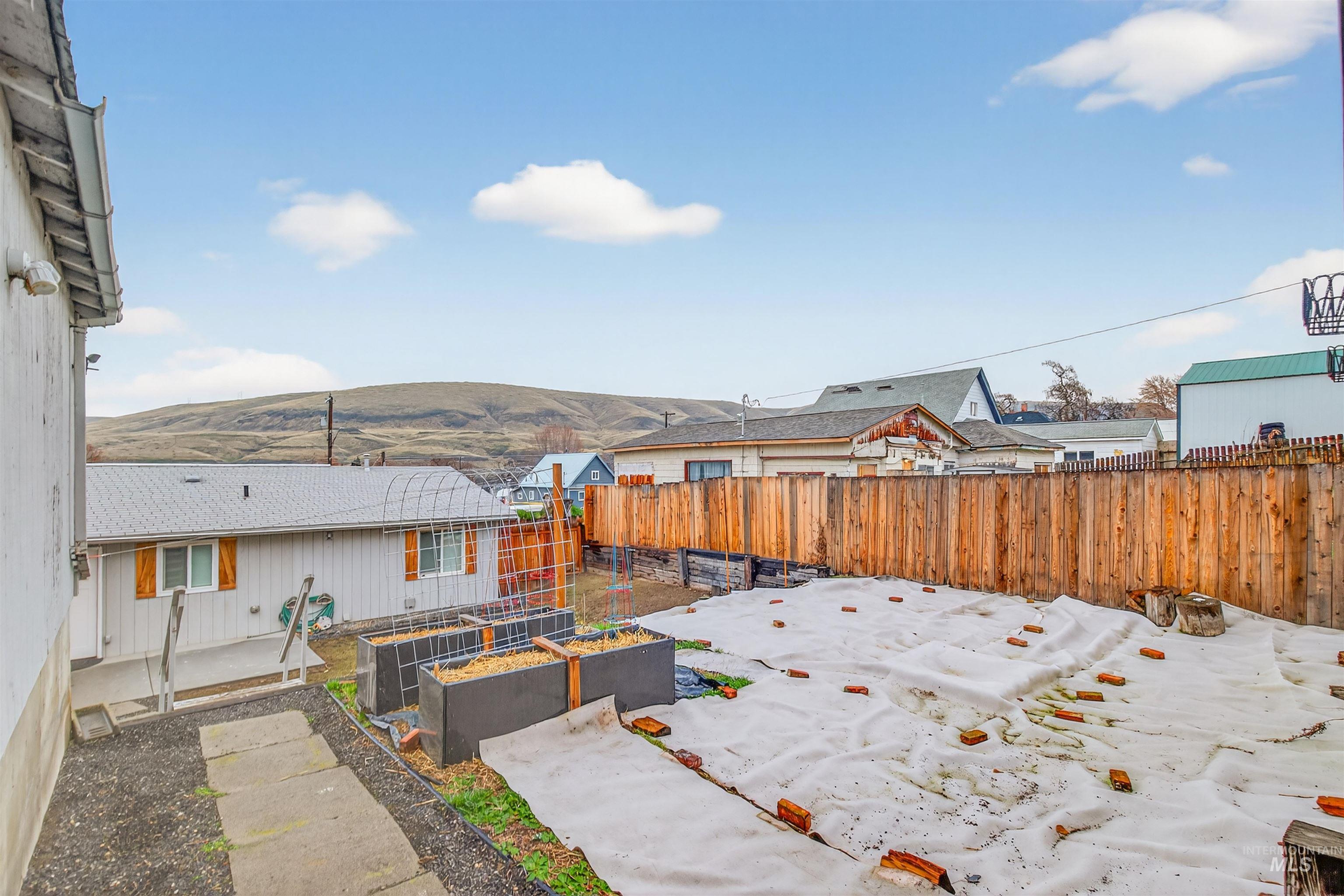 406 2nd Street Asotin, WA 99402 - Photo 27 of 37 Fenced backyard with a garden and a patio