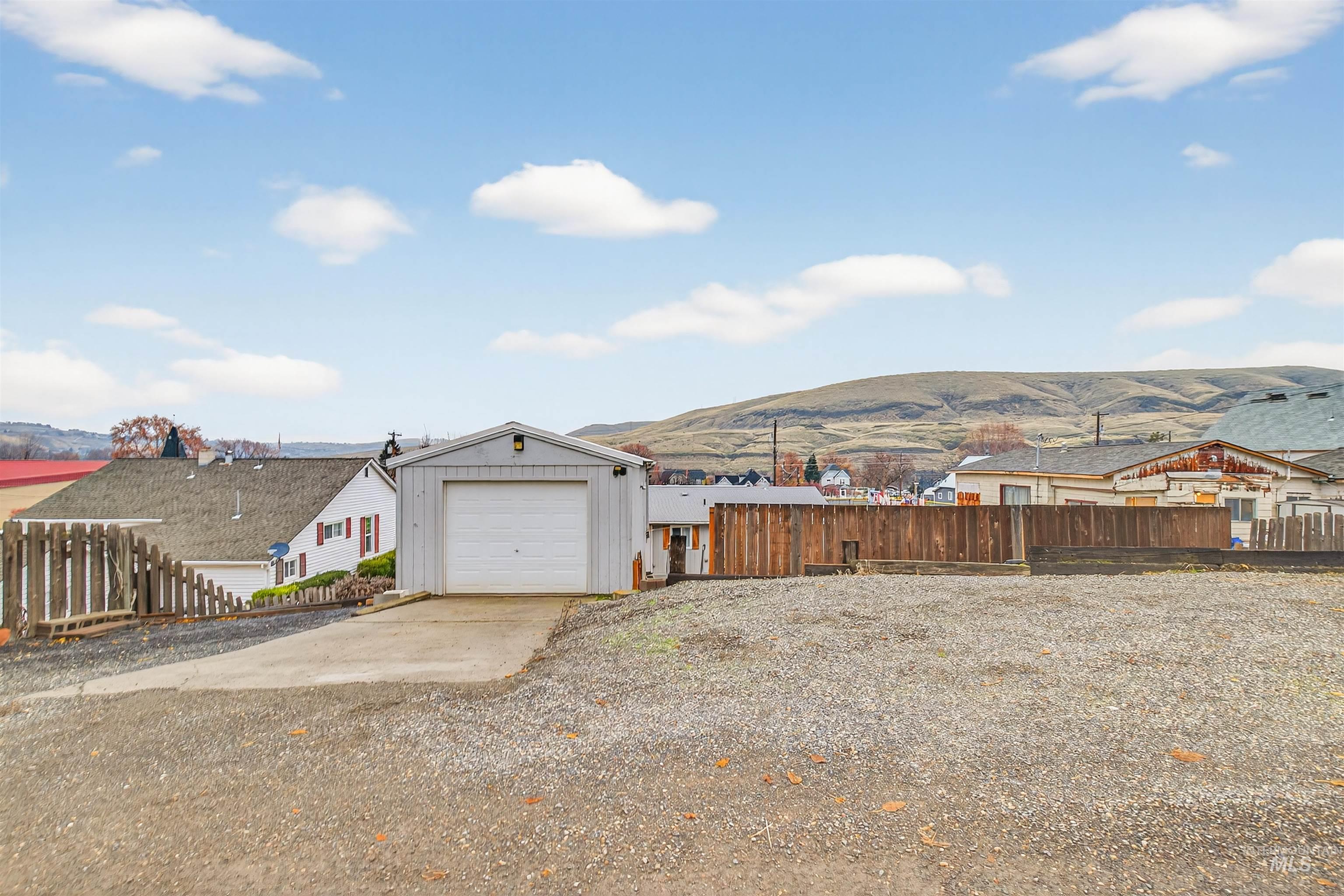 406 2nd Street Asotin, WA 99402 - Photo 30 of 37 View of yard with a mountain view, a garage, and concrete driveway