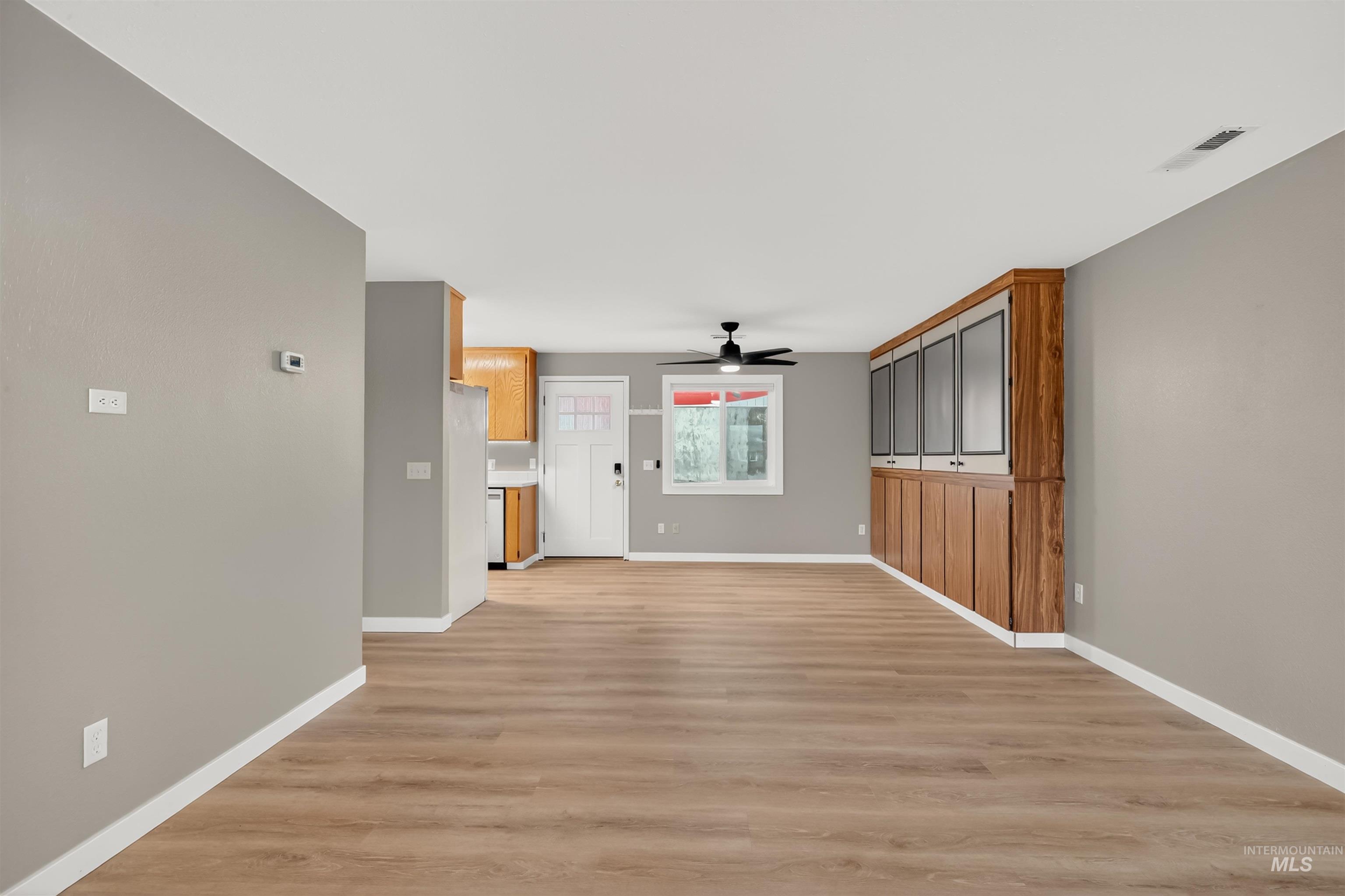 406 2nd Street Asotin, WA 99402 - Photo 3 of 25 Unfurnished living room with light wood-style floors and a ceiling fan