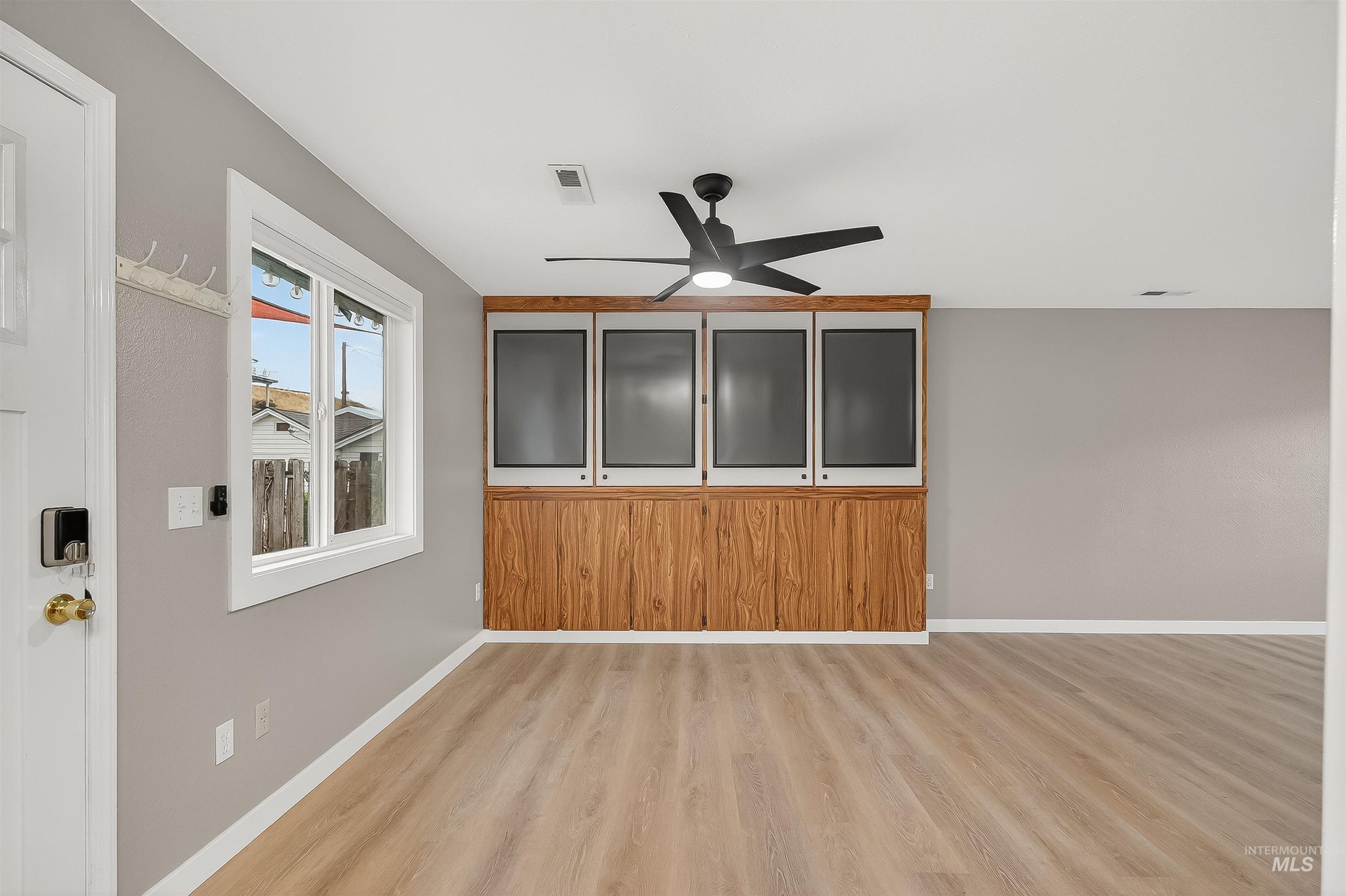406 2nd Street Asotin, WA 99402 - Photo 5 of 37 Empty room featuring a ceiling fan and light wood-style flooring