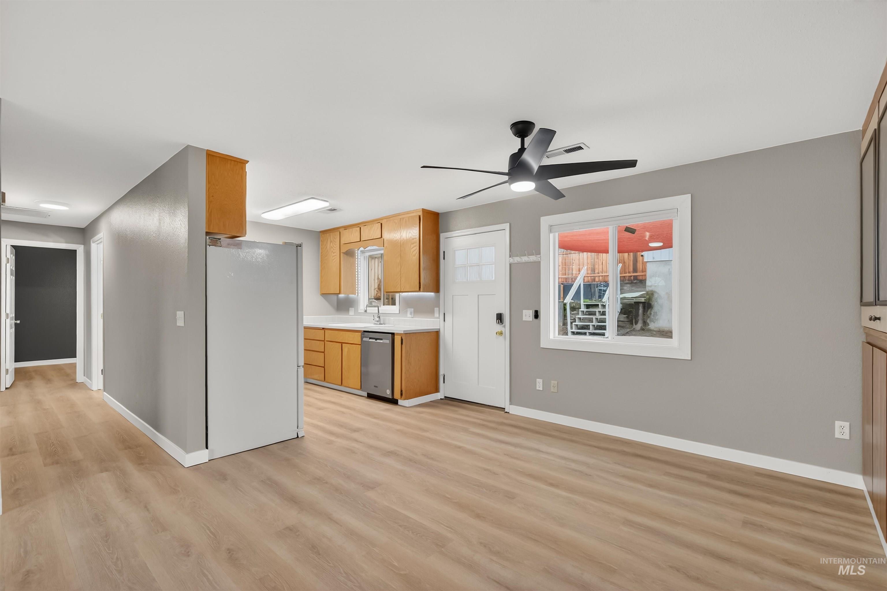 406 2nd Street Asotin, WA 99402 - Photo 6 of 37 Kitchen with light countertops, freestanding refrigerator, ceiling fan, dishwasher, and brown cabinets