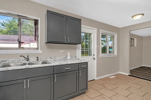 a kitchen with a sink cabinets and window