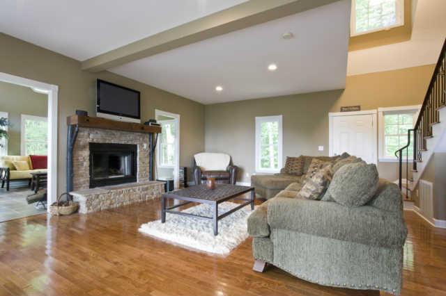 172 Ingman Cliff Road Tracy City, TN 37387 - Photo 8 of 18 View of great room showing woodburning fireplace, wood floors and custom iron stair rails!
