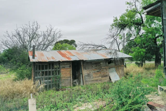 a view of house with yard and outdoor seating