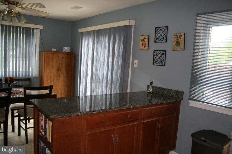 Sliding doors adjoin to patio and fenced yard.