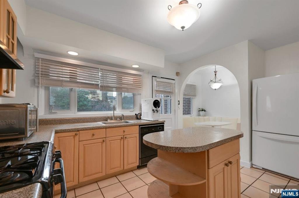 497 Oakdene Avenue Ridgefield, NJ 07657 - Photo 11 of 28 a kitchen with a sink appliances and cabinets