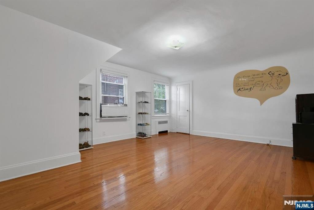 497 Oakdene Avenue Ridgefield, NJ 07657 - Photo 14 of 28 a view of an empty room with a window and wooden floor