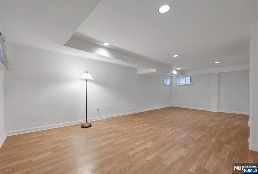 497 Oakdene Avenue Ridgefield, NJ 07657 - Photo 15 of 28 a view of an empty room with wooden floor and a window