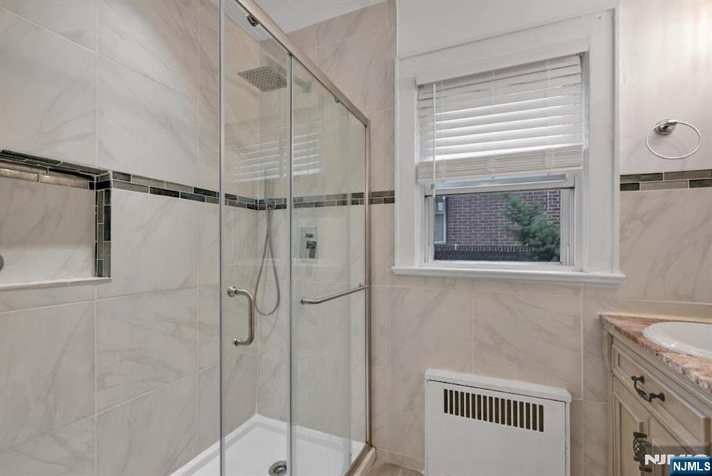 497 Oakdene Avenue Ridgefield, NJ 07657 - Photo 24 of 28 a bathroom with a shower and a sink