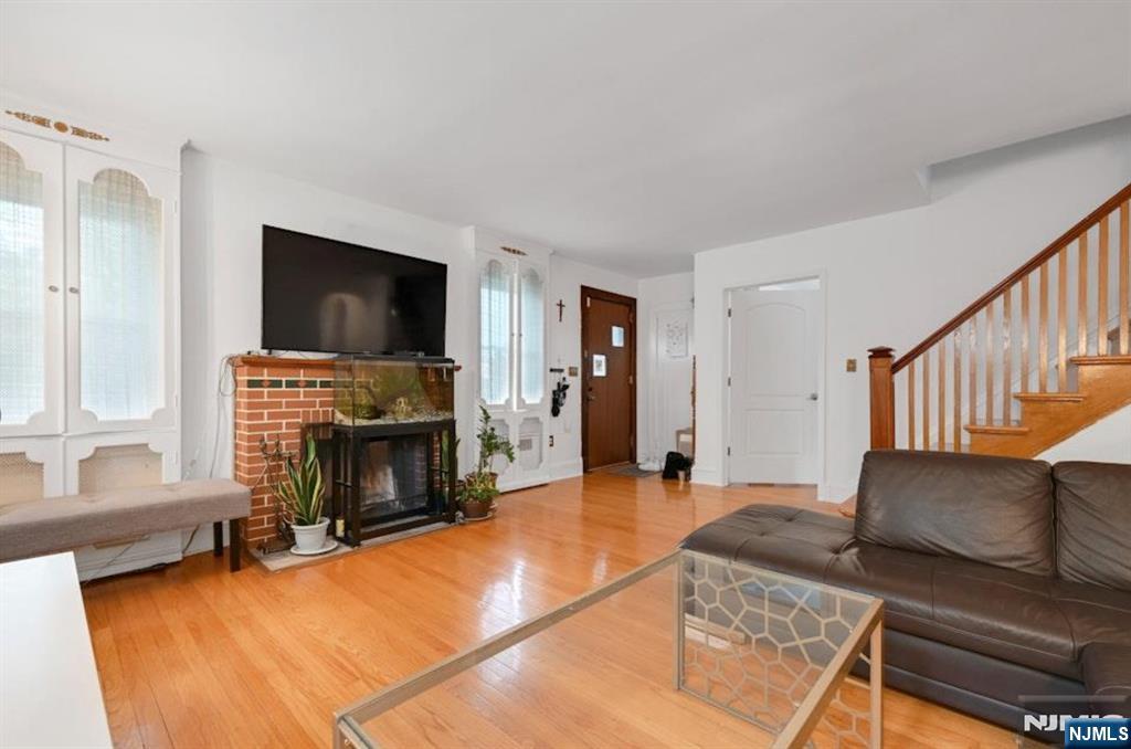 497 Oakdene Avenue Ridgefield, NJ 07657 - Photo 8 of 28 a living room with furniture and a fireplace