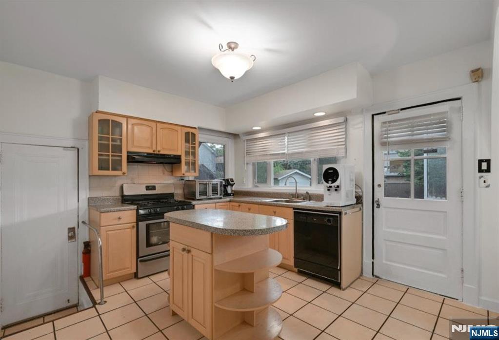 497 Oakdene Avenue Ridgefield, NJ 07657 - Photo 10 of 28 a kitchen with stainless steel appliances granite countertop a sink and stove top oven