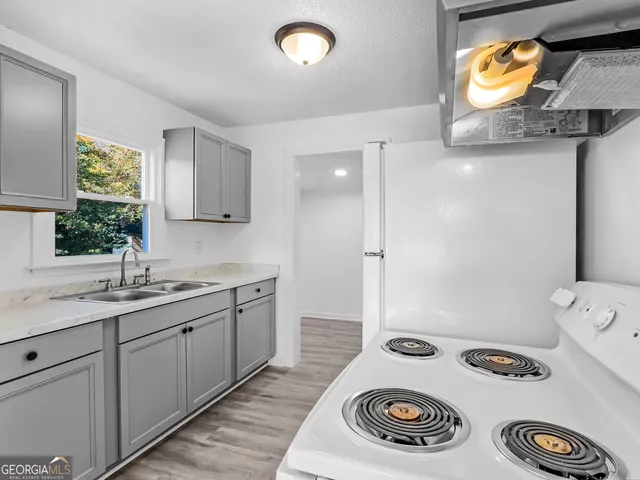 a kitchen with a sink cabinets and a window