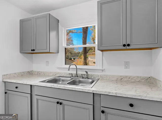 a kitchen with stainless steel appliances granite countertop a stove and a refrigerator