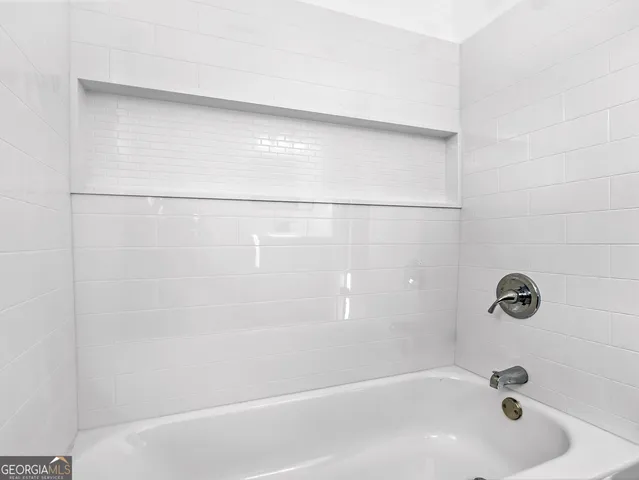 a bathroom with a granite countertop toilet and a shower