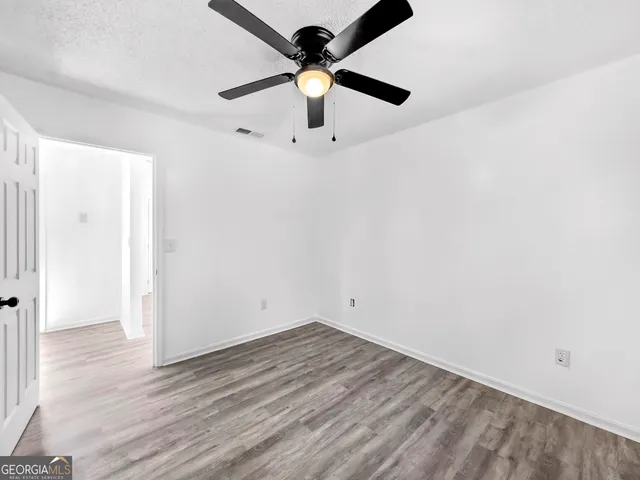a view of a room with wooden floor