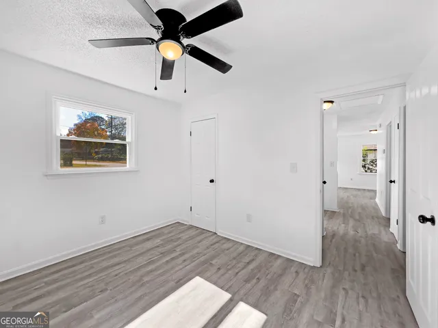 a view of empty room with wooden floor